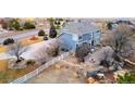 Stunning backyard featuring a patio, fire pit, rock landscaping, and white fence at 9407 E 147Th Pl, Brighton, CO 80602