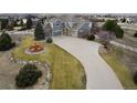 Sweeping aerial view of this estate with long driveway and landscaped front yard featuring a water fountain at 9407 E 147Th Pl, Brighton, CO 80602