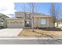 Charming two-story home with an attached two-car garage and mature trees at 6690 S Fenton St, Littleton, CO 80123