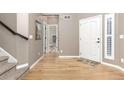 Inviting foyer with hardwood floors, neutral walls, and a view into the downstairs bathroom at 6690 S Fenton St, Littleton, CO 80123