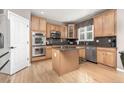 Kitchen boasts stainless steel appliances, granite countertops, and ample cabinet space at 6690 S Fenton St, Littleton, CO 80123