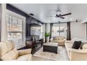 Living room with beige sofas, a large TV, and a fireplace at 5570 Nepal St, Denver, CO 80249