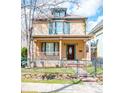 Charming two-story home with a welcoming front porch and decorative shutters at 433 N Ogden St, Denver, CO 80218
