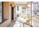 Inviting front porch with classic columns, potted plants, and charming curb appeal at 433 N Ogden St, Denver, CO 80218