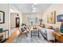 Bright living room features hardwood floors, large bay window, comfortable seating, and stylish decor at 433 N Ogden St, Denver, CO 80218