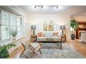 Inviting living room featuring hardwood floors, a comfortable couch, and natural light from the window at 433 N Ogden St, Denver, CO 80218