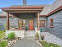 Charming covered front porch with stone accents and lovely landscaping at 845 Urban St, Lakewood, CO 80401