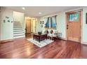 Cozy living room featuring hardwood floors, a stylish rug, and ample natural light at 845 Urban St, Lakewood, CO 80401