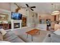 Bright living room with fireplace, high ceilings, and open layout, flowing into the kitchen at 12513 Alcott St, Broomfield, CO 80020