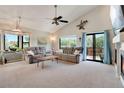 Spacious living room with large windows, vaulted ceiling and sliding glass doors to the backyard at 12513 Alcott St, Broomfield, CO 80020