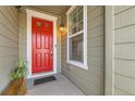 Red front door entryway with a welcome mat and small plant at 8036 E 53Rd Dr, Denver, CO 80238