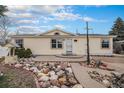 Charming single-story home with a unique xeriscaped front yard and inviting entrance at 1683 Monroe St, Strasburg, CO 80136