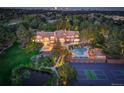 Aerial view of the property showcasing the pool, tennis court, landscaped grounds, and beautiful home at 5 Walden Ln, Cherry Hills Village, CO 80121