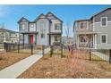 Stylish two-story home with grey siding, a cozy front porch, and a beautifully landscaped front yard at 18059 French Creek Ave, Parker, CO 80134