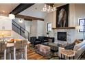 Cozy living room featuring a stone fireplace, exposed wood beams, and stylish furnishings at 208 N Ridge St, Breckenridge, CO 80424