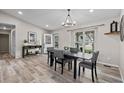 Inviting dining room with modern light fixture, a stylish table set, and lots of natural light from the window at 20908 E Dorado Cir, Centennial, CO 80015