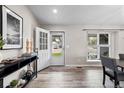 View of the home's bright entryway with natural light, wood-look floors, and stylish decor at 20908 E Dorado Cir, Centennial, CO 80015