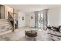 Bright entryway features a staircase, decorative mirror, and a sunlit window with patterned curtains at 9958 Milwaukee St, Thornton, CO 80229