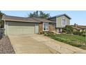 Attractive home with a two-car garage, brick and siding exterior, and a well-kept lawn and driveway at 9958 Milwaukee St, Thornton, CO 80229