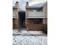 Exterior view showcasing access to condo units with brick accents and stairs at 3328 S Ammons St # 4-104, Lakewood, CO 80227