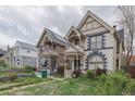 Street view of a vintage home featuring distinctive architectural design and well-kept landscaping at 2245 Julian St, Denver, CO 80211