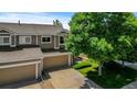 Elevated view showcasing the home's architectural details, two-car garage, and well-manicured lawn at 2430 E 109Th Dr, Northglenn, CO 80233