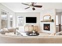Modern living room with a sleek fireplace, contemporary decor, and ample natural light at 14850 Munich Ave, Parker, CO 80134