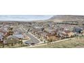 Scenic aerial view showcases a vibrant neighborhood nestled against rolling hills and distant mountains at 19760 W 59Th Dr, Golden, CO 80403
