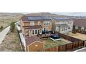 Backyard view of a two-story home, featuring a deck, storage shed, and privacy fence at 19760 W 59Th Dr, Golden, CO 80403