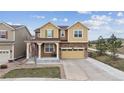 Charming two-story home featuring a two-car garage, covered porch, and manicured front lawn at 19760 W 59Th Dr, Golden, CO 80403