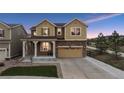 Charming two-story home with a well-manicured lawn and a two-car garage and stone accents in a suburban neighborhood at 19760 W 59Th Dr, Golden, CO 80403