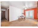 Cozy dining area with carpeted floors, ceiling fan, and a set table for four at 12046 W Green Mountain Dr, Lakewood, CO 80228