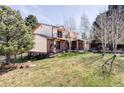 Beautiful shot of the back of the house showing the open yard and brick accents at 8687 N Pinery Pkwy, Parker, CO 80134