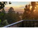 Scenic mountain view at sunset from the balcony with foreground trees creating a serene outdoor space at 8687 N Pinery Pkwy, Parker, CO 80134