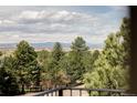 Scenic mountain views from this property, featuring lush trees and an open landscape at 8687 N Pinery Pkwy, Parker, CO 80134