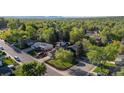 A high aerial view showcasing a neighborhood with mature trees and lush green landscaping at 10909 W 65Th Way, Arvada, CO 80004