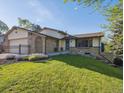 Charming home with a manicured lawn and brick accents on a sunny day at 10909 W 65Th Way, Arvada, CO 80004