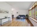 Bright living room with hardwood floors, bay window, modern decor, and lots of natural light at 10909 W 65Th Way, Arvada, CO 80004