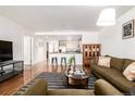 Inviting living room with hardwood floors, breakfast bar and earth-tone decor at 1560 Blake St # 810, Denver, CO 80202