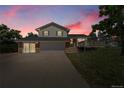 Charming two-story home boasts a spacious driveway, an attached garage, and a welcoming deck, perfect for outdoor entertaining at 2882 Gentry Ct, Watkins, CO 80137