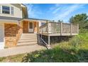 Inviting front porch with steps leading to the door, framed by brick accents and a well-manicured lawn at 2882 Gentry Ct, Watkins, CO 80137