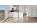 Bright, eat-in kitchen featuring stainless steel appliances and luxury vinyl plank flooring at 2992 Oxley St, Strasburg, CO 80136