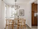 Light dining room features a round wood table with decorative centerpiece and modern lighting at 916 Florence St, Aurora, CO 80010