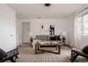 Bright living room with neutral tones, a cozy sofa, and modern decor at 916 Florence St, Aurora, CO 80010