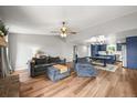 Spacious living room features hardwood floors, a ceiling fan, and an open floorplan at 3881 S Bahama St, Aurora, CO 80013