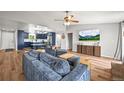 Open concept living space showcasing hardwood floors and an expansive layout with a vaulted ceiling at 3881 S Bahama St, Aurora, CO 80013