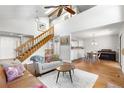 Spacious living room featuring a staircase, hardwood floors, and an open layout at 6375 S Jackson St, Centennial, CO 80121