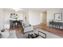 Inviting living and dining area with modern decor, wood floors, neutral colors, and an abundance of natural light at 955 Eudora St # 505E, Denver, CO 80220