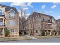 Stone condos featuring arched windows, wrought iron fencing and professionally maintained landscaping at 150 S Madison St # 303, Denver, CO 80209