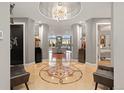 Grand foyer with designer tile flooring, columns and a statement chandelier at 150 S Madison St # 303, Denver, CO 80209